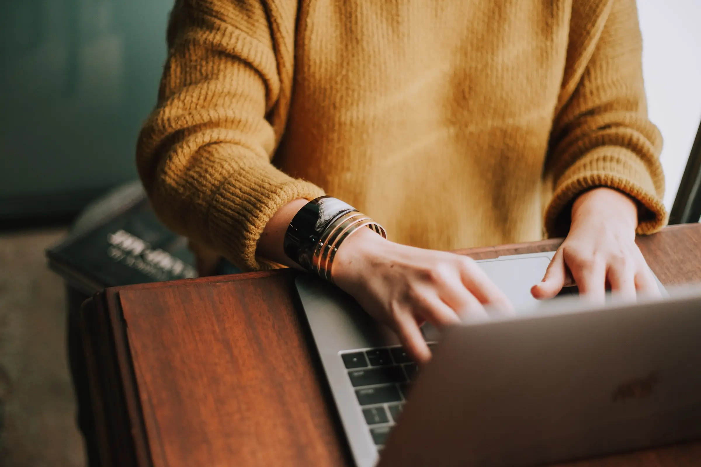 A professional customizing their digital profile on a laptop, highlighting skills, achievements, and work samples for job applications.